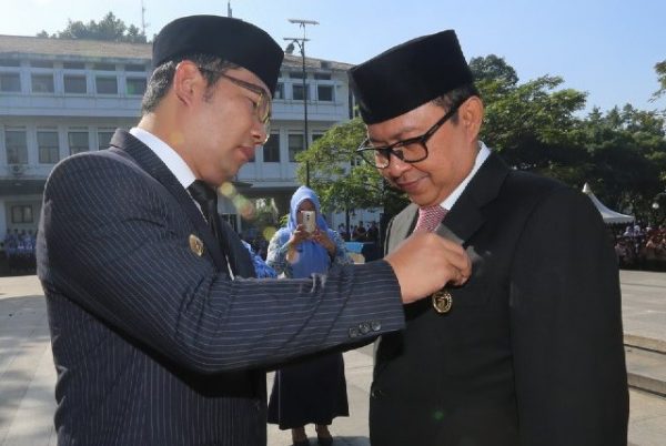 Wali Kota Bandung Ridwan Kamil menyematkan penghargaan Satya Lencana Karya Satya 30 tahun kepada Sekretaris Daerah Kota Bandung Yossi Irianto, saat peringatan Hari Otonomi Daerah tingkat Kota Bandung di Plaza Bale Kota Bandung, Selasa (2/5). by Meiwan Humas Pemkot Bandung.